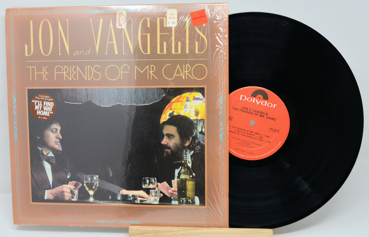 Vinyl record with cover featuring 'Jon Vangelis and The Friends of Mr. Cairo' on a white background