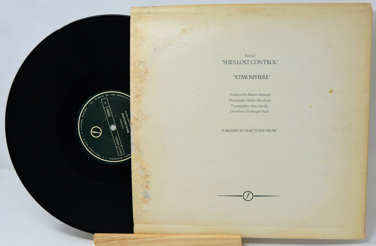 Vinyl record with a textured cover on a light gray background