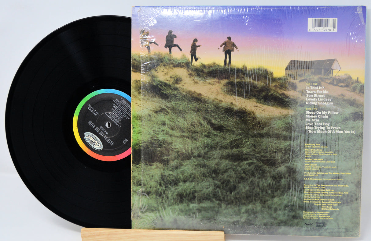 Vinyl record with colorful label and cover featuring a scenic illustration.