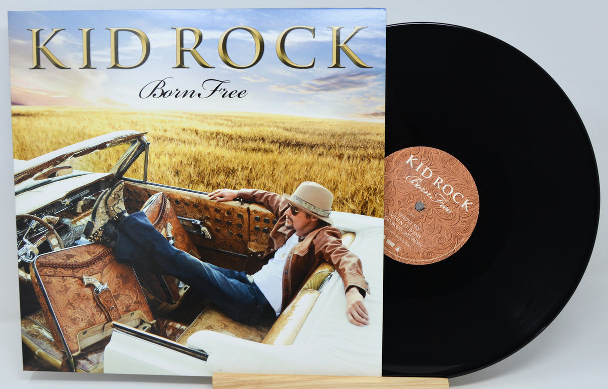 Kid Rock's 'Born Free' vinyl record album shown with the printed cover on the left and the black LP record partially pulled out on the right, set against a light gray background.