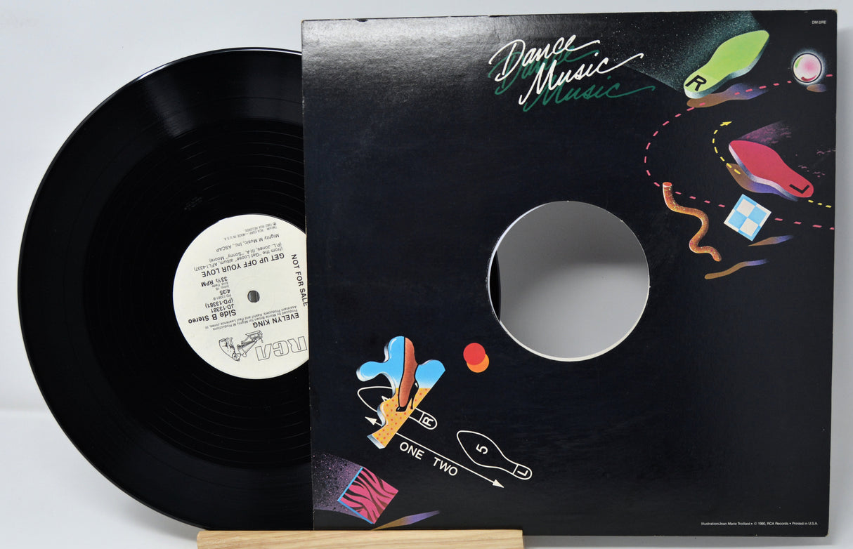 Vinyl record with colorful cover design on a light gray background