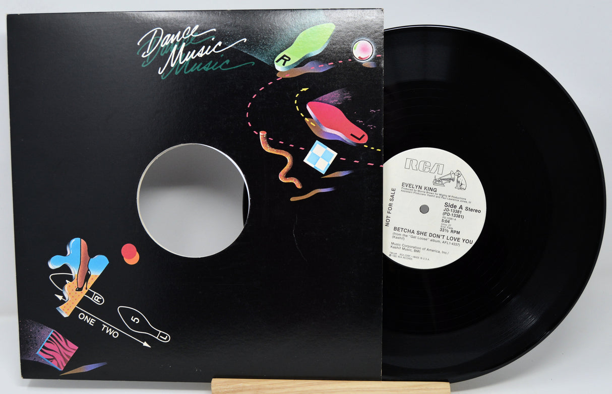 Vinyl record with colorful cover and visible label on a white background