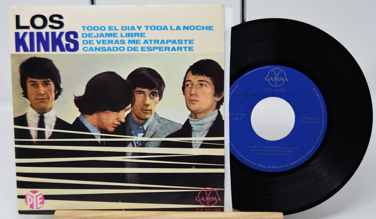 Vinyl record with blue label and cover featuring a band on a white background