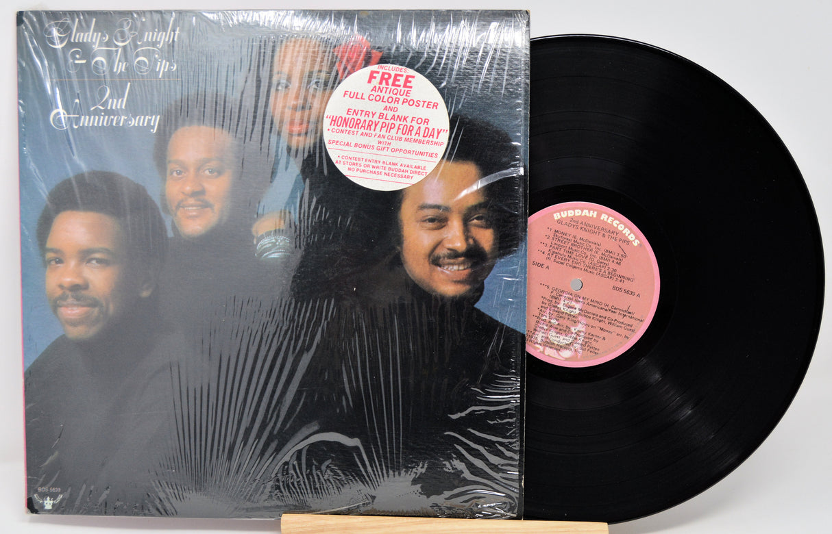 Vinyl record with cover featuring a group of people, on a white background