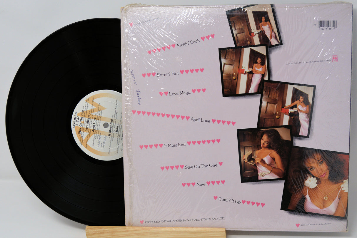 Vinyl record with a cover featuring multiple photos of a woman on a light gray background