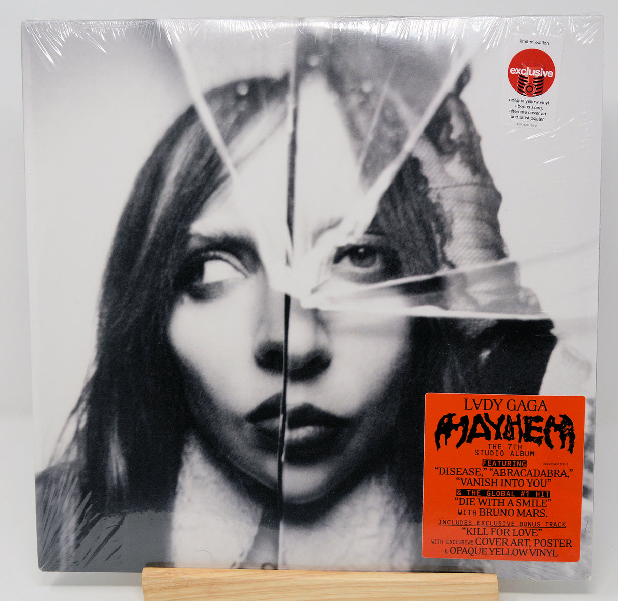 Vinyl record with a black and white portrait and red label on a white background