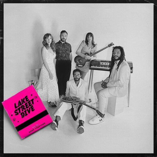 A vinyl record cover featuring the band Lake Street Dive with a pink and white design. The band members are seated and posing with musical instruments in the background.