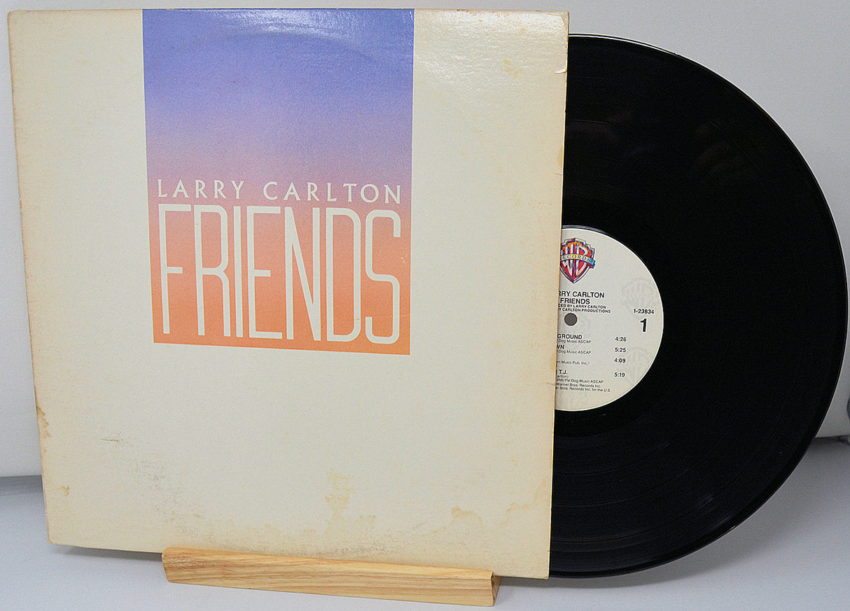 Front cover of Larry Carlton Friends vinyl LP with album title and record partially visible
