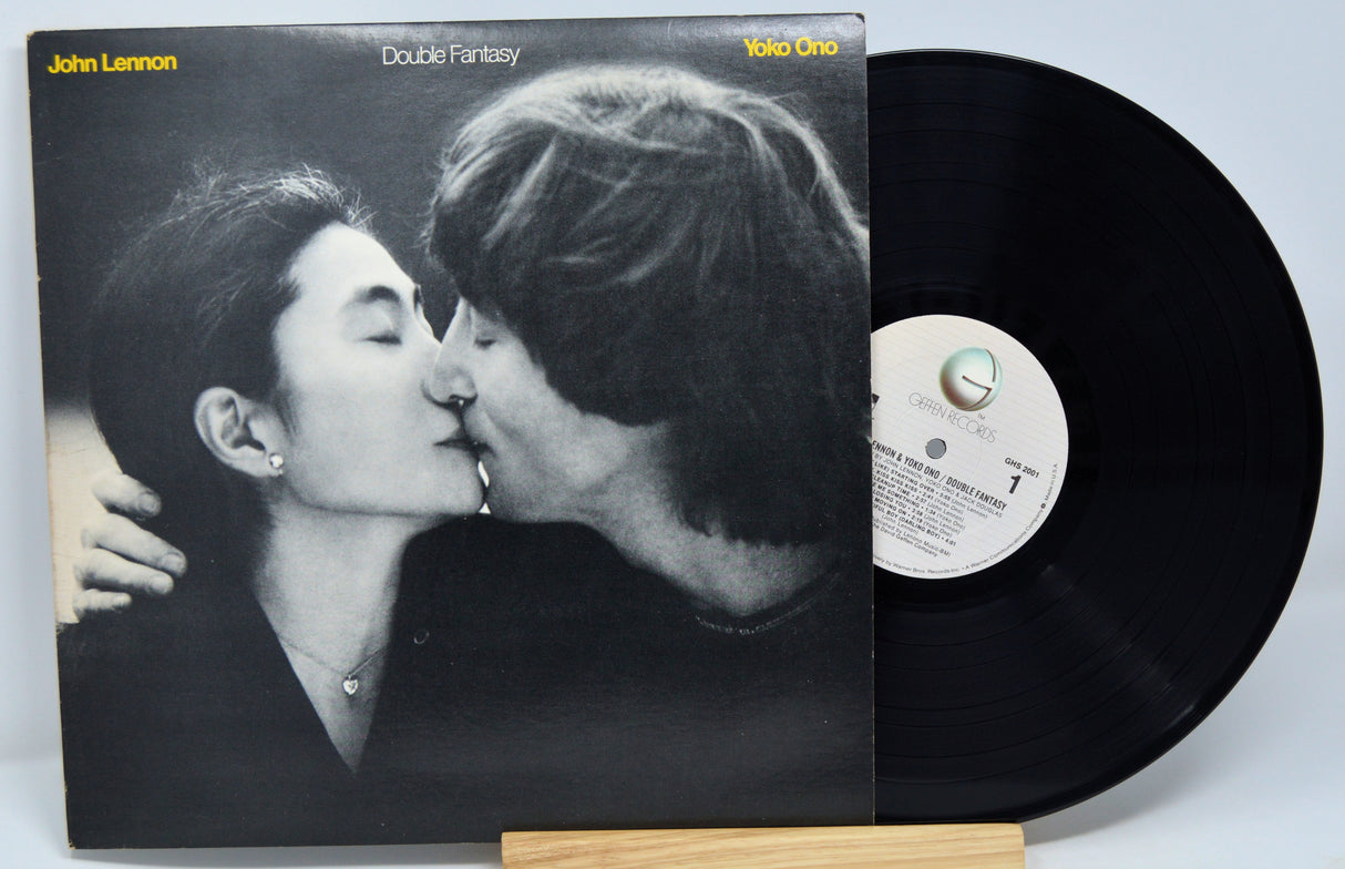 Vinyl record with cover showing a couple kissing, on a white background