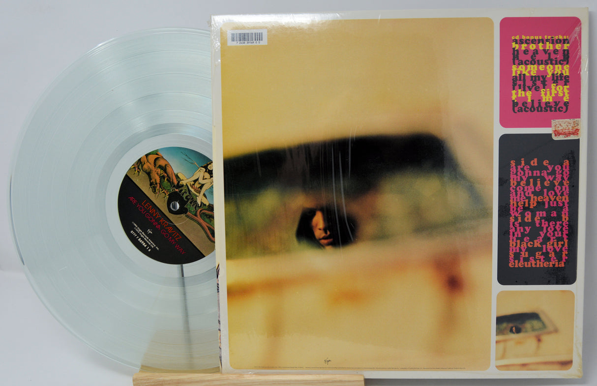 Vinyl record with cover featuring a person playing guitar, on a white background