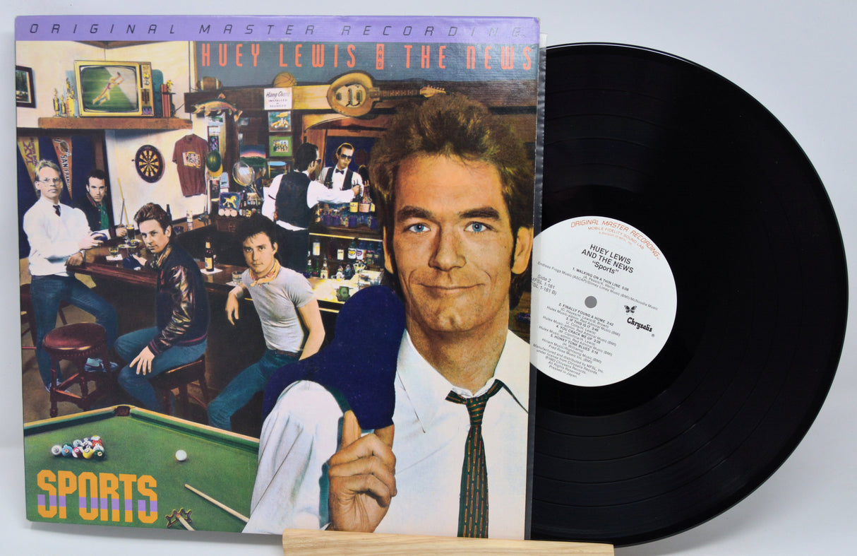 Vinyl record with cover featuring a man in a bar setting and 'Sports' text.