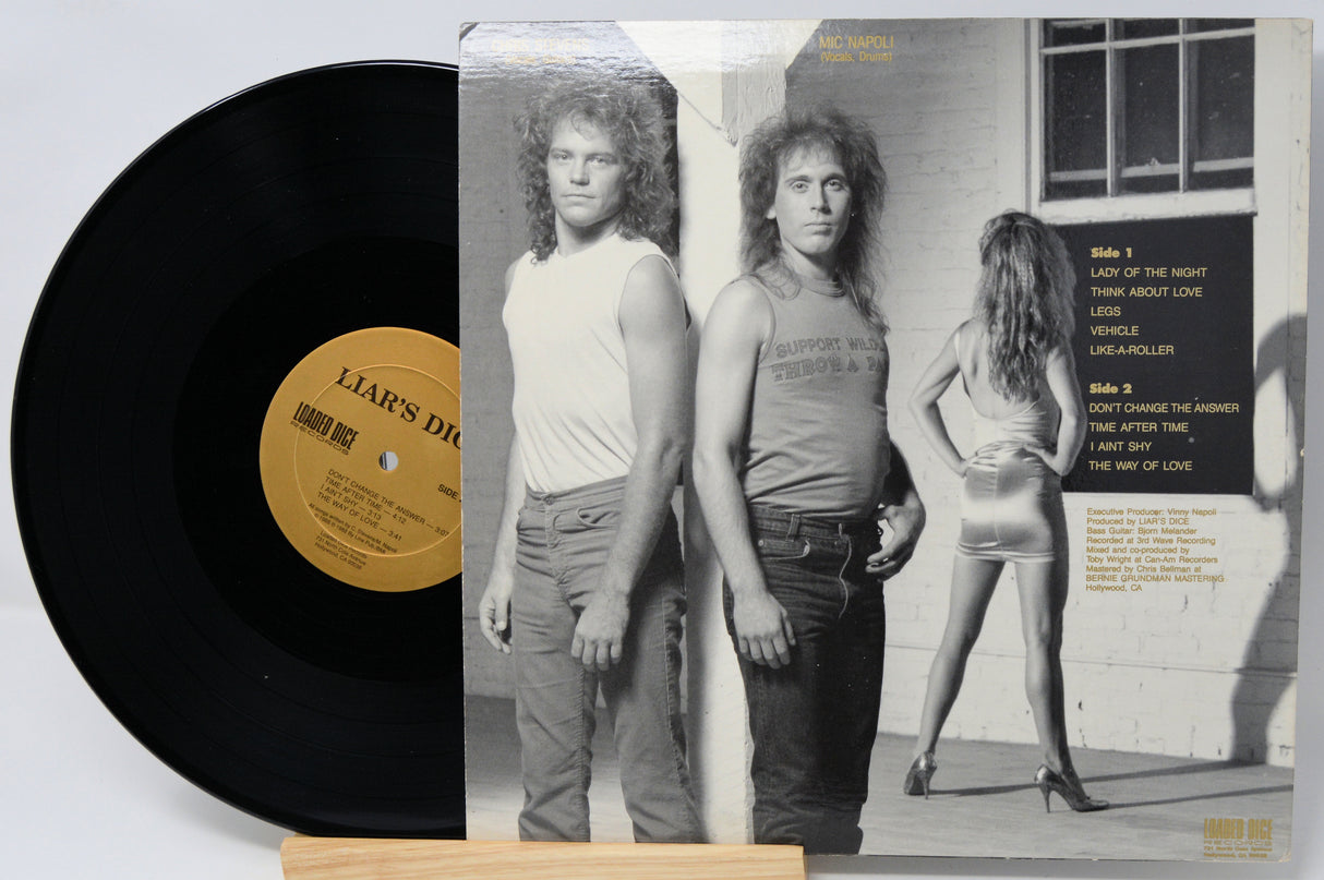 Vinyl record with cover featuring a black and white photo of two people and a woman.
