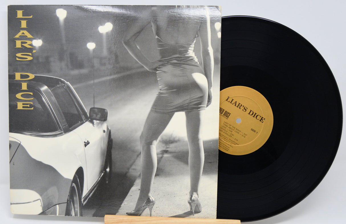 Vinyl record with cover featuring a woman and car, labeled 'Liar's Dice'.