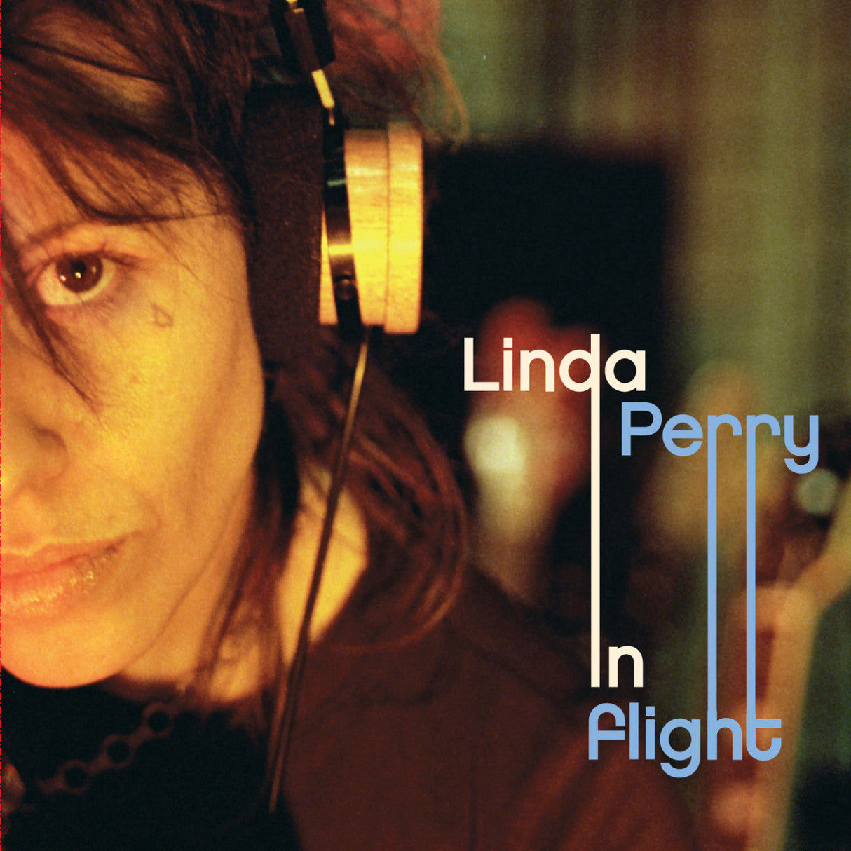 Close-up of Linda Perry In Flight album cover art showing artist in headphones