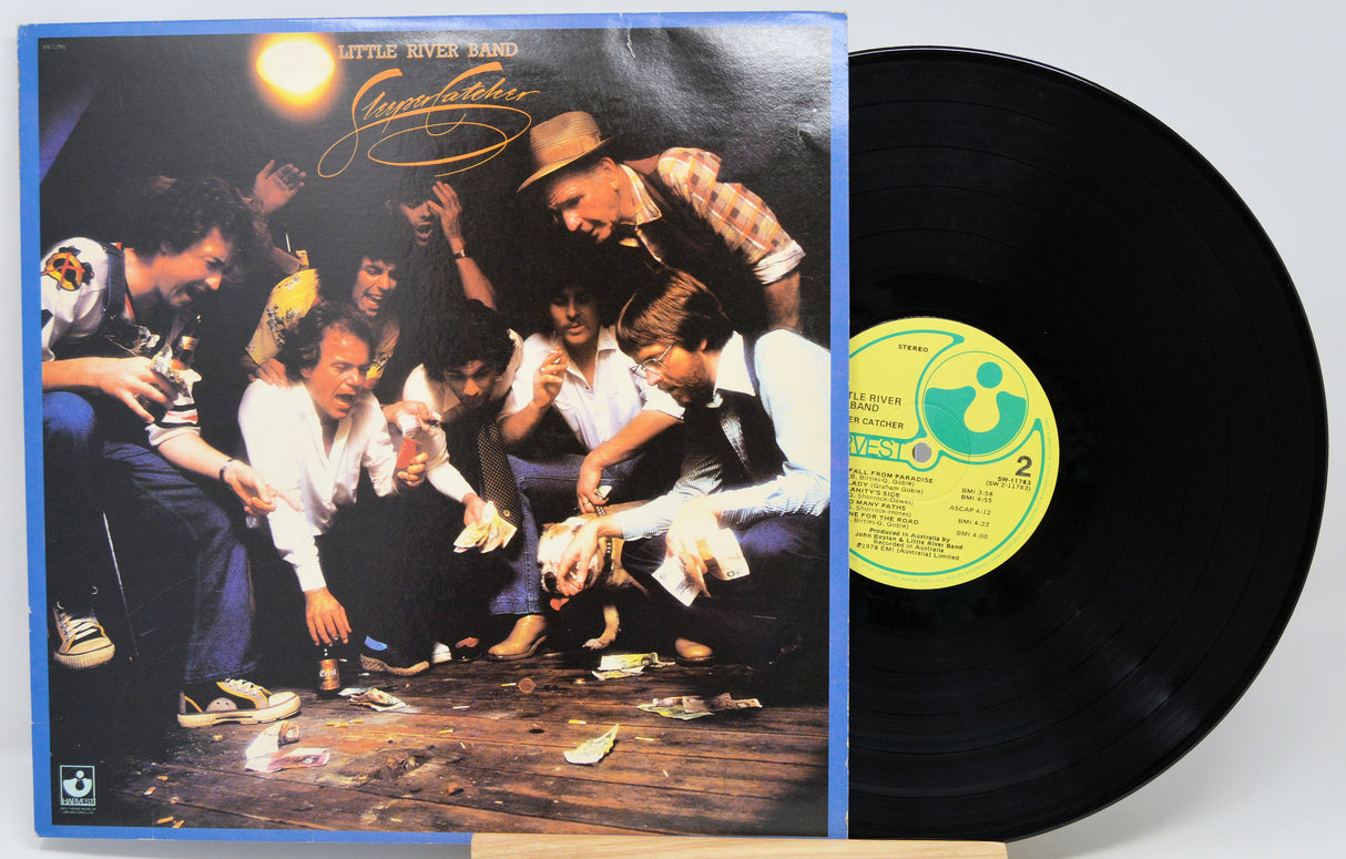A vinyl record album shown with its cover sleeve and the black record partially pulled out. The sleeve features a group photo with the title 'Little River Band' and 'Significance' visible.