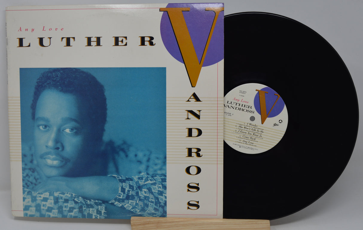 Vinyl record with cover featuring a portrait and 'Luther Vandross' text on a gray background
