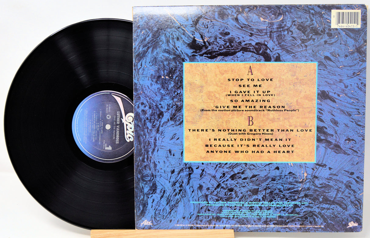 Vinyl record with a newspaper-style cover featuring black and white images and text.