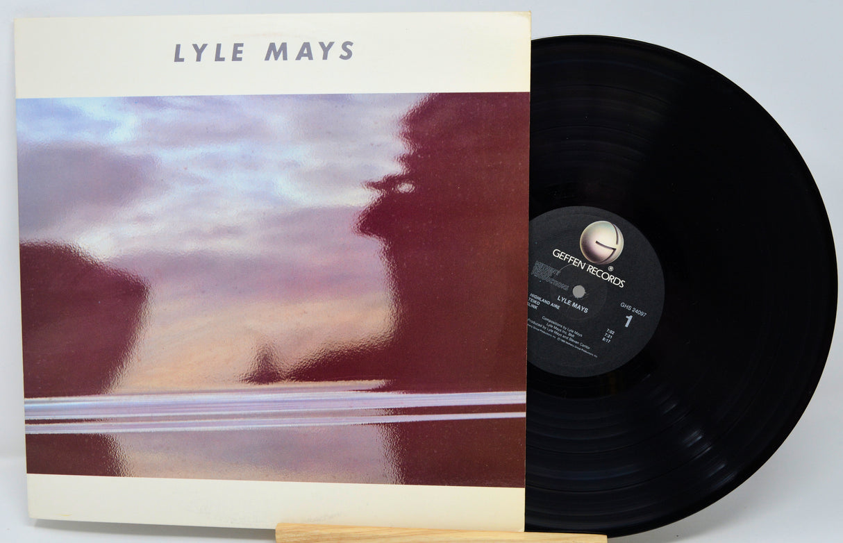 Vinyl record with cover featuring a blurred landscape and 'LYLE MAYS' text.