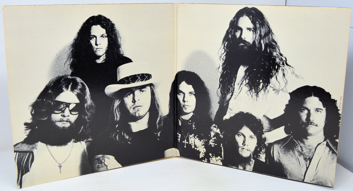 Album cover with black and white portraits of band members on a beige background
