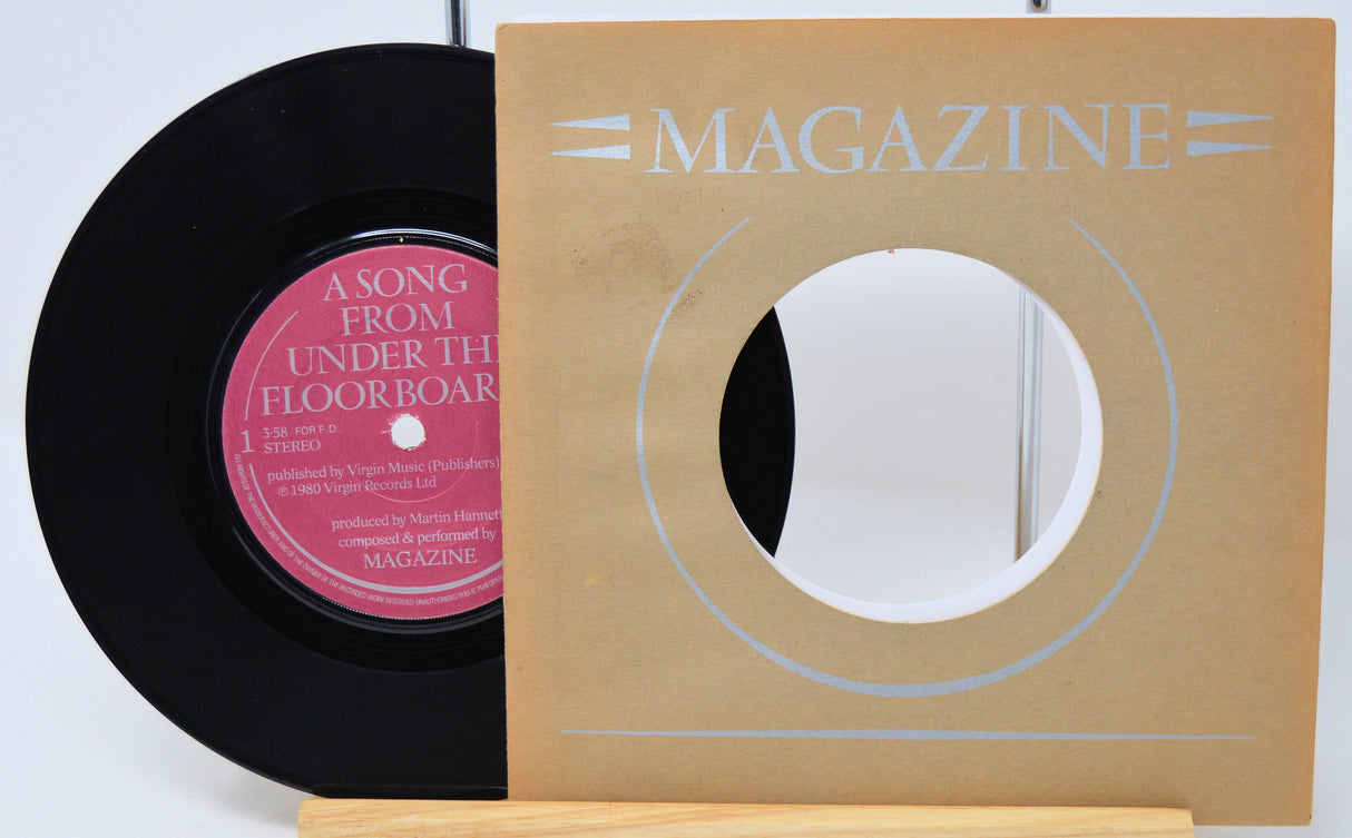 Vinyl record with pink label and 'Magazine' record cover on a white background