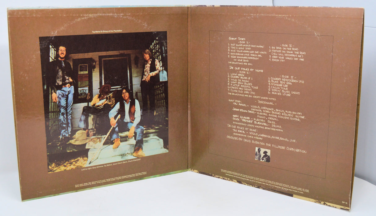 Album cover with two people playing guitar, text on a brown background