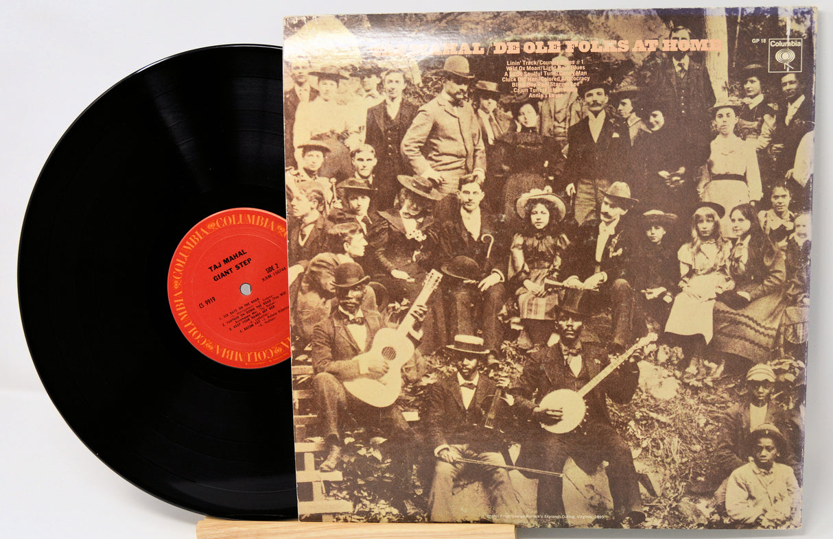 Vinyl record with a vintage-style album cover featuring people playing instruments.