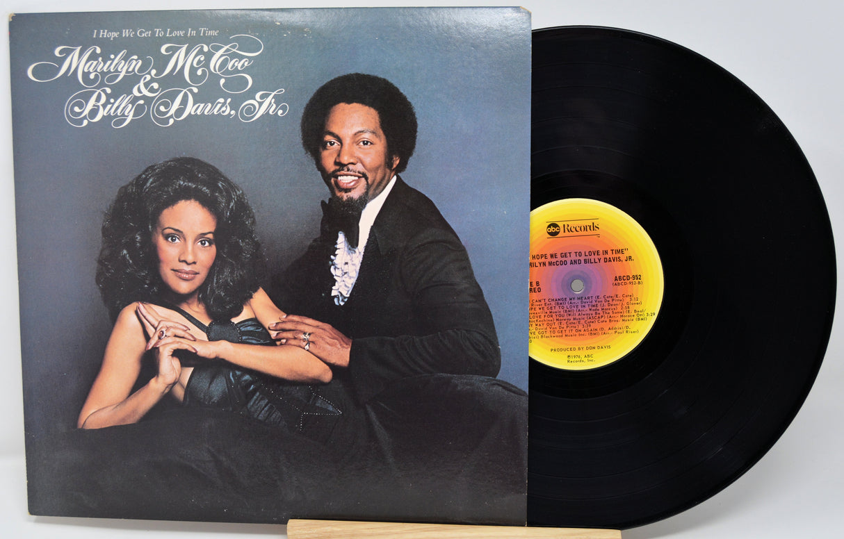 Vinyl record with cover featuring a couple and a yellow label on a white background