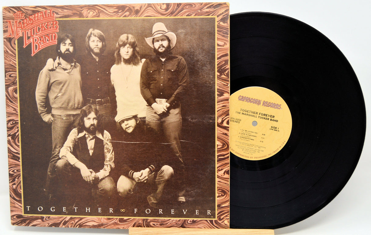 Vinyl record with cover featuring a group of people and text 'Together Forever'.
