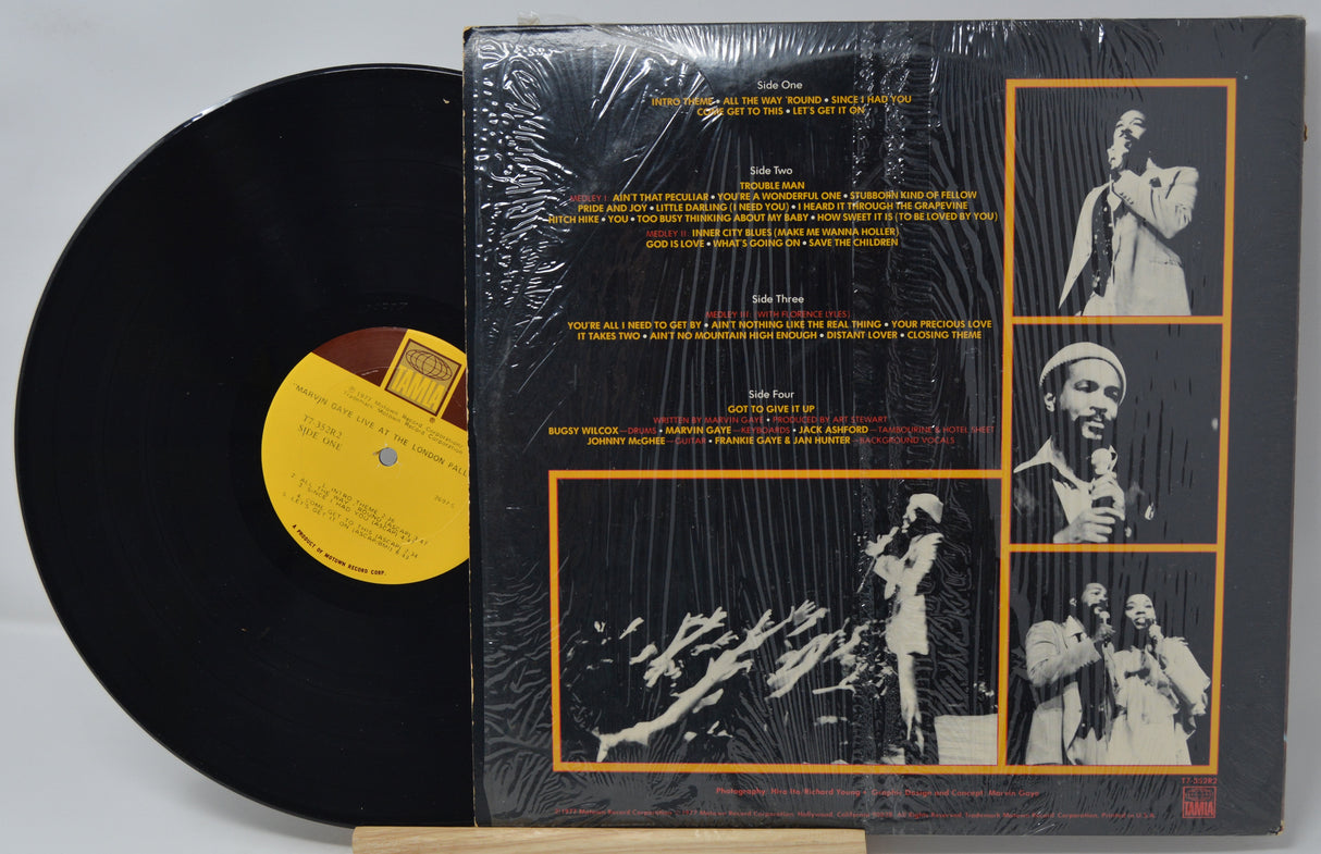 Vinyl record with a yellow label and its cover displaying black and white images of a musician.
