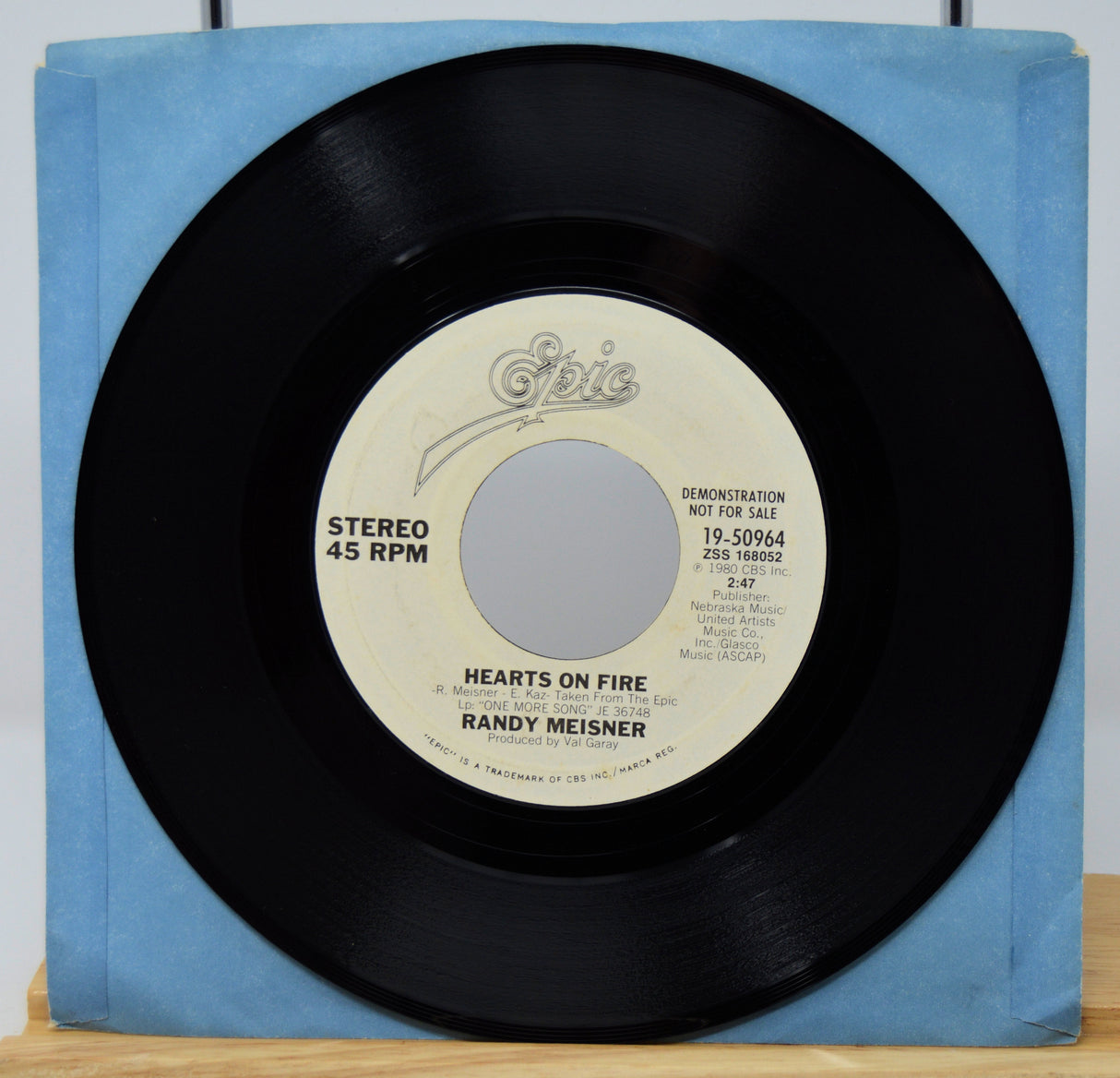 45 RPM record with blue cover on a white background