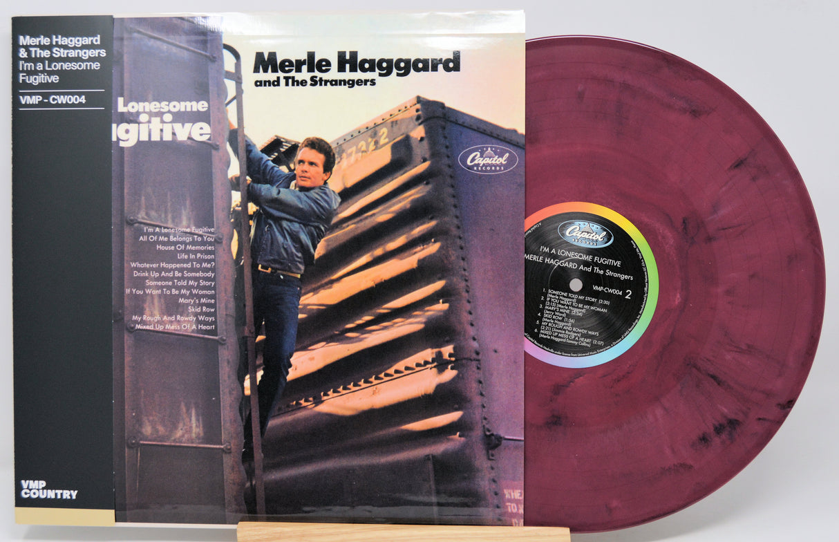 Merle Haggard and The Strangers 'Lonesome Wintertime' vinyl record LP with its cover sleeve, featuring a maroon marbled record and a black inner label.