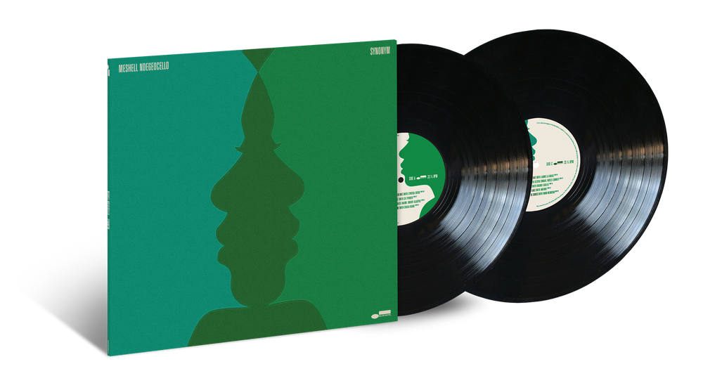 A vinyl record album with its square cover partially pulled open, showing two black records. The cover is solid green with a dark green layered face silhouette and small white text at the top.