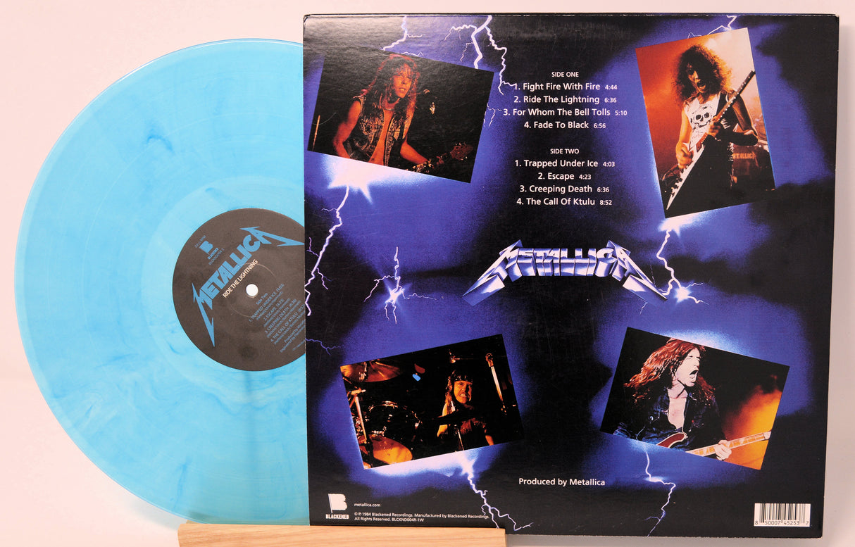 Blue vinyl record with its cover featuring images of a band member and tracklist.