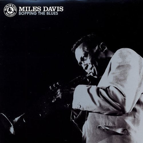 Album cover featuring Miles Davis playing the trumpet with text 'Miles Davis Bopping the Blues' on a black background.