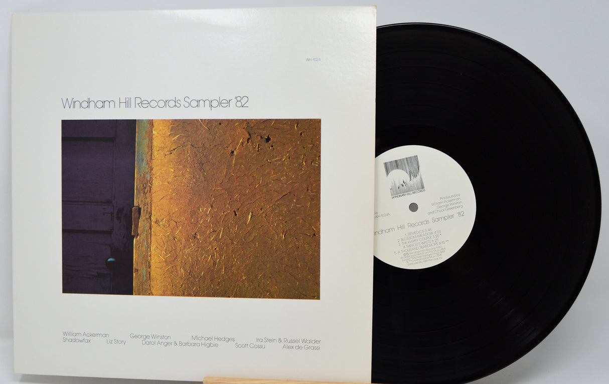 Vinyl record and cover with 'Windham Hill Records Sampler 82' text on a white background