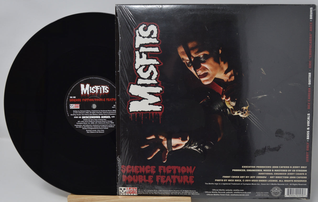 Vinyl record and its cover featuring the band 'Misfits' on a gray background