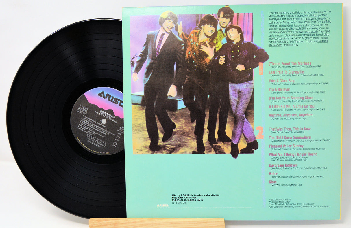 Vinyl record with cover featuring a band and text on a white background
