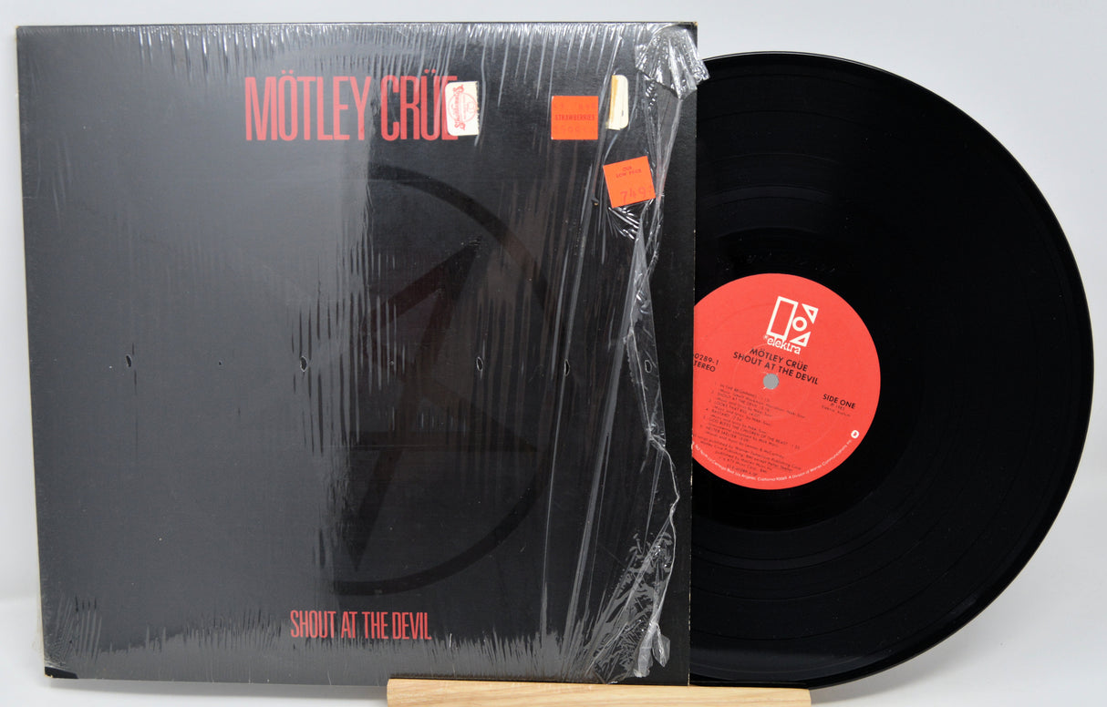 Vinyl record with 'Mötley Crüe' album cover showing 'Shout at the Devil'.