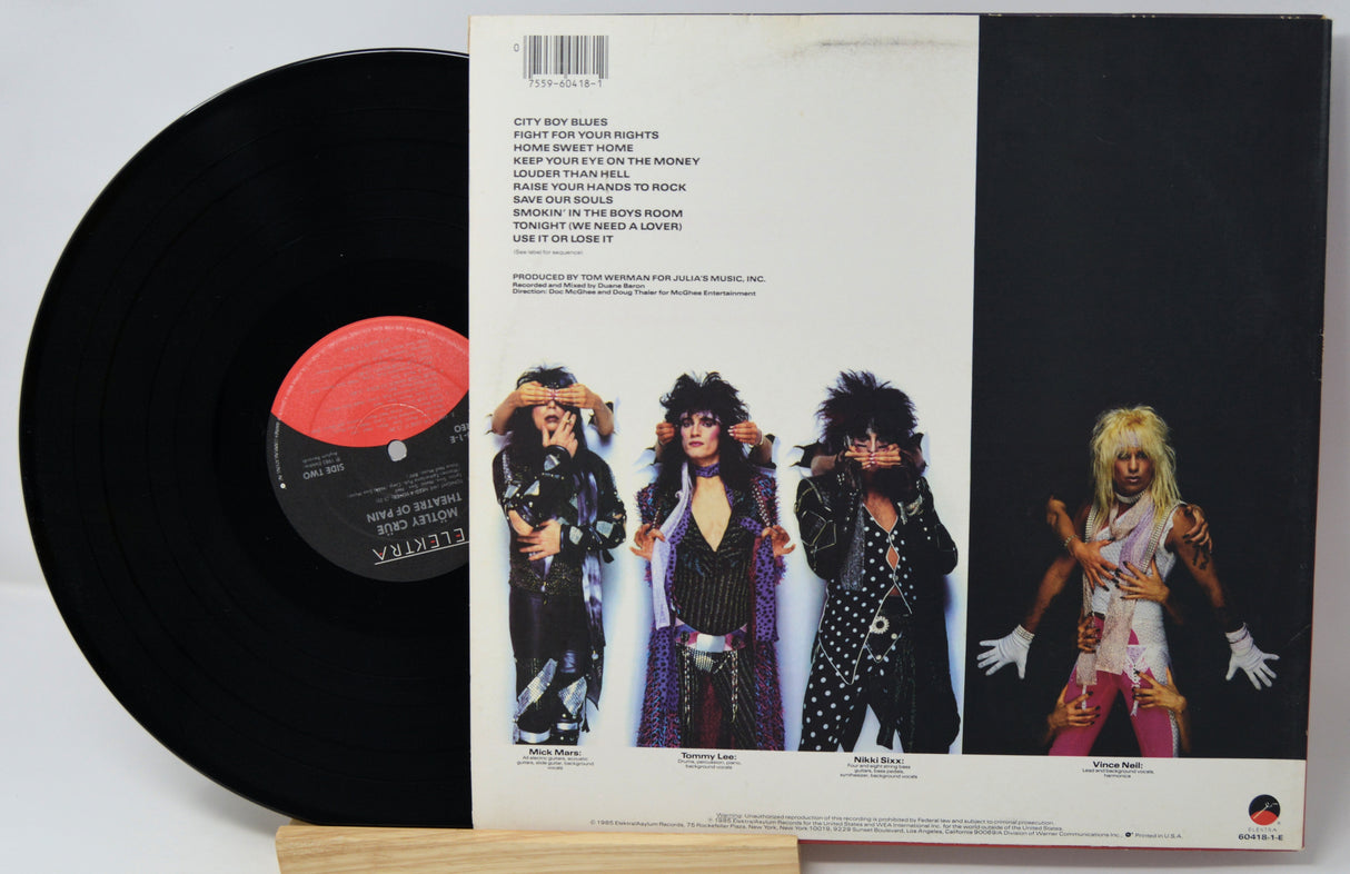 Vinyl record with a colorful cover featuring band members and text.