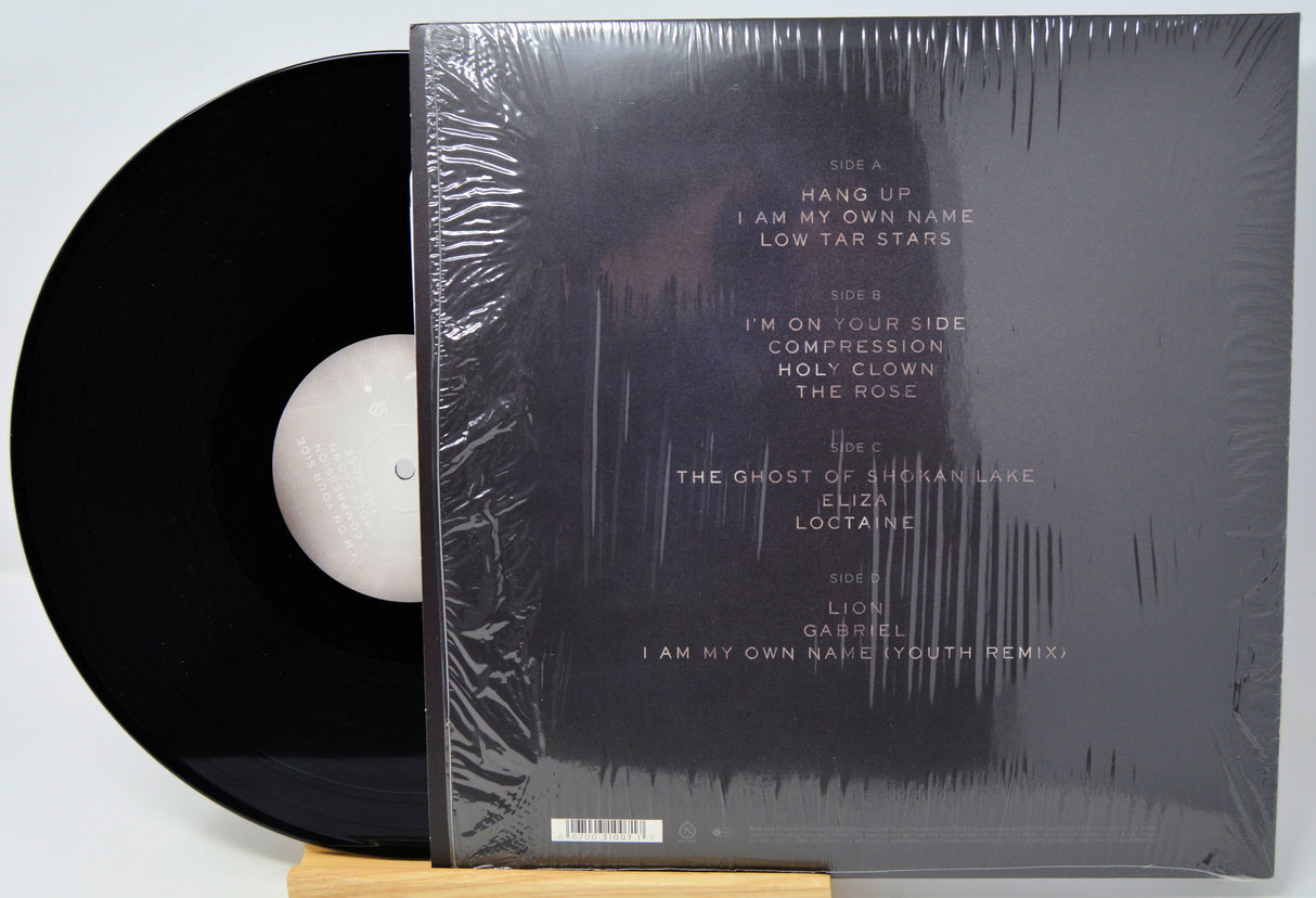 Vinyl record with a black cover on a white background