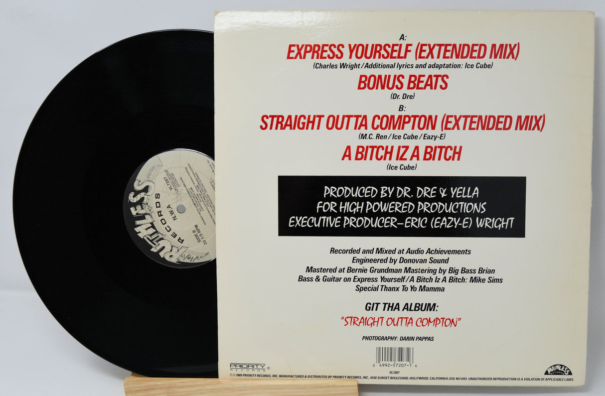 Vinyl Cover feature five men sitting on a benches with their feet up.