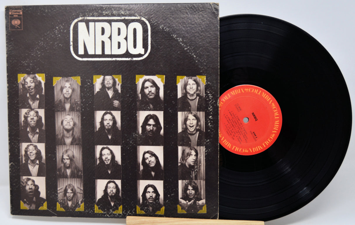 NRBQ vinyl record album with the black LP partially pulled from the sleeve, showing the front cover artwork and a red center label.