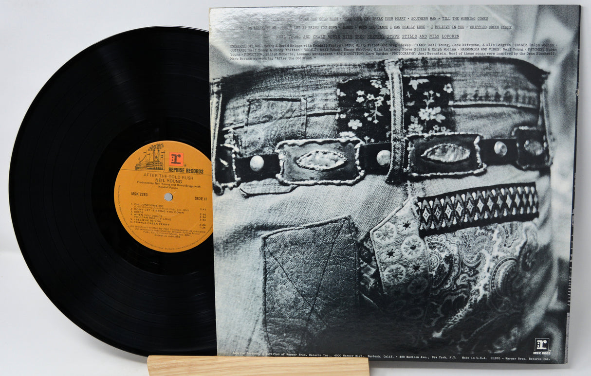 Vinyl record with a black and white album cover featuring intricate patterns.