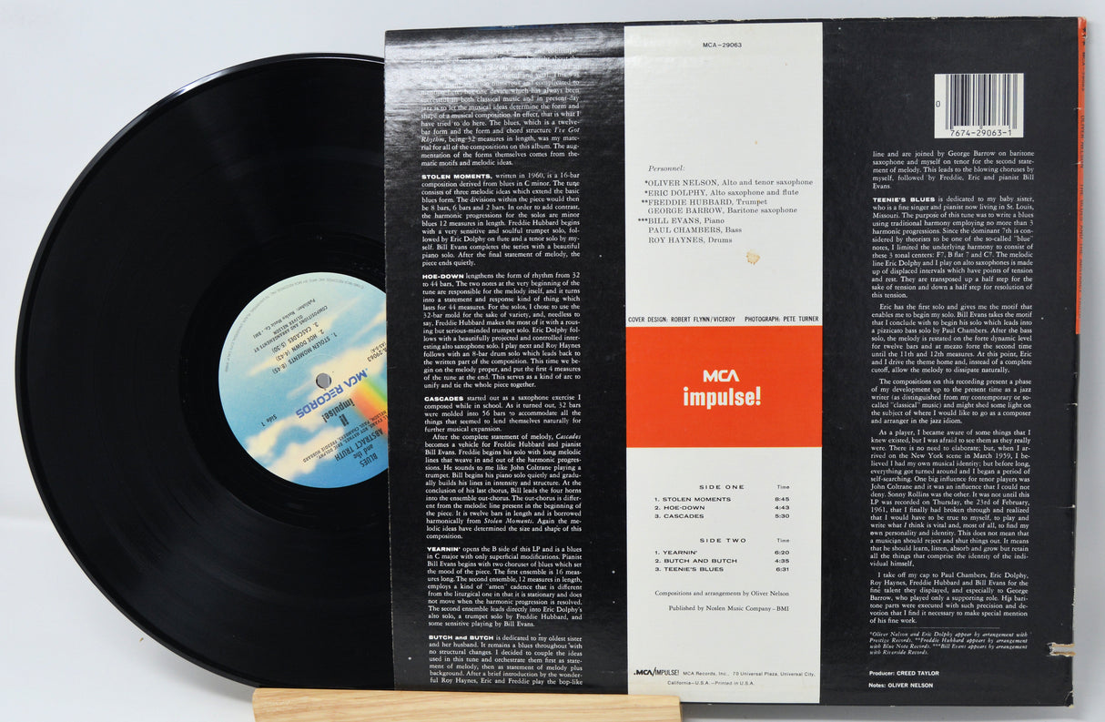 Vinyl record with its cover displaying text and a logo on a white background