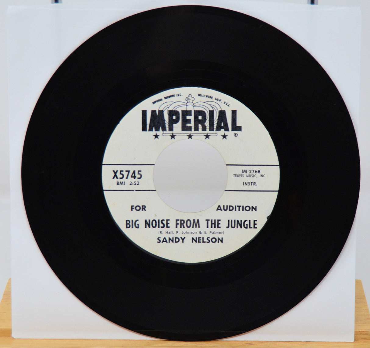 Vinyl record with 'Imperial' label and text on a white background