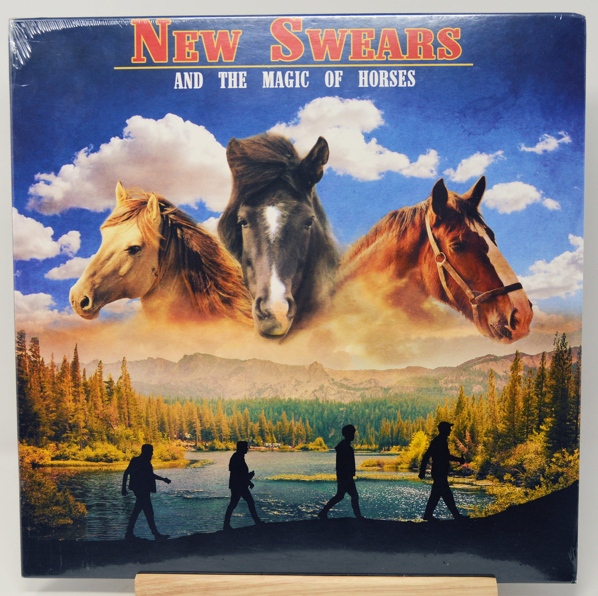 Album cover with horses and people walking by a lake, titled 'New Swears and the Magic of Horses'.