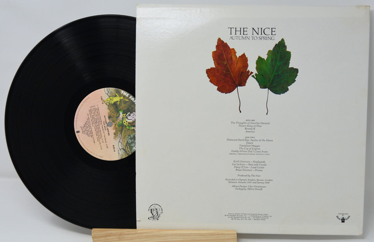 Vinyl record with a white cover featuring autumn leaves and text.