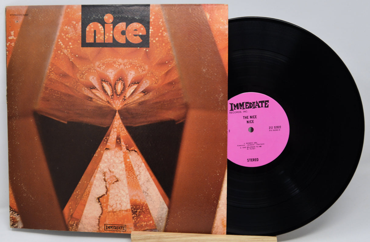 Vinyl record with a colorful cover and pink label on a white background