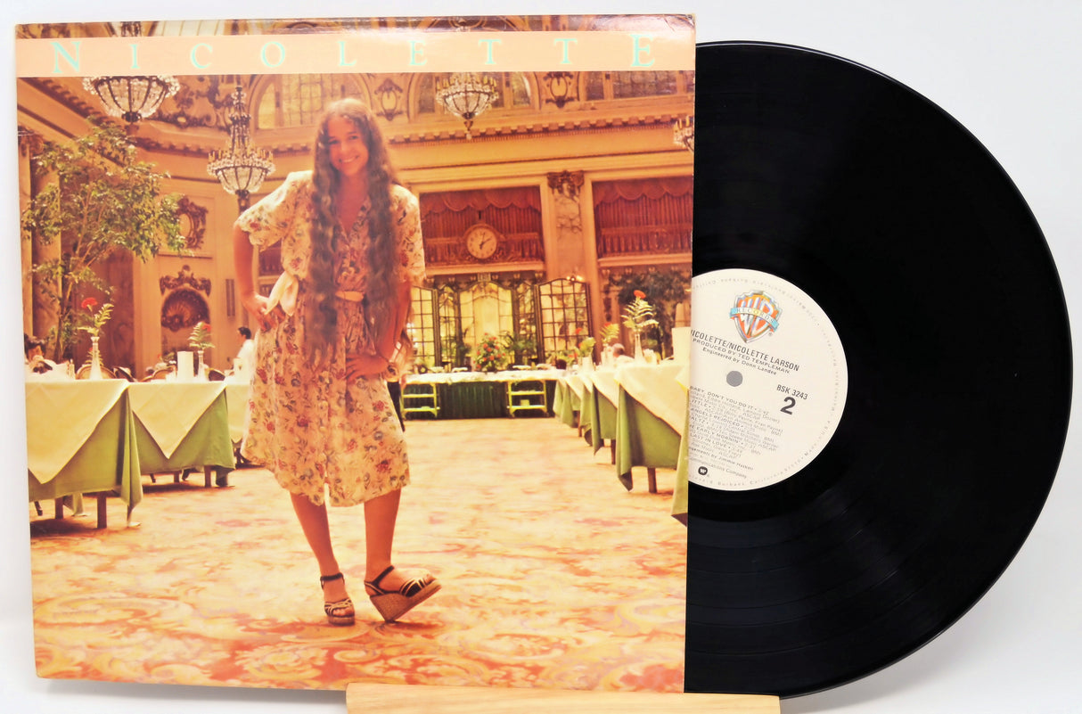 Vinyl record with a cover featuring a person in a grand hall.