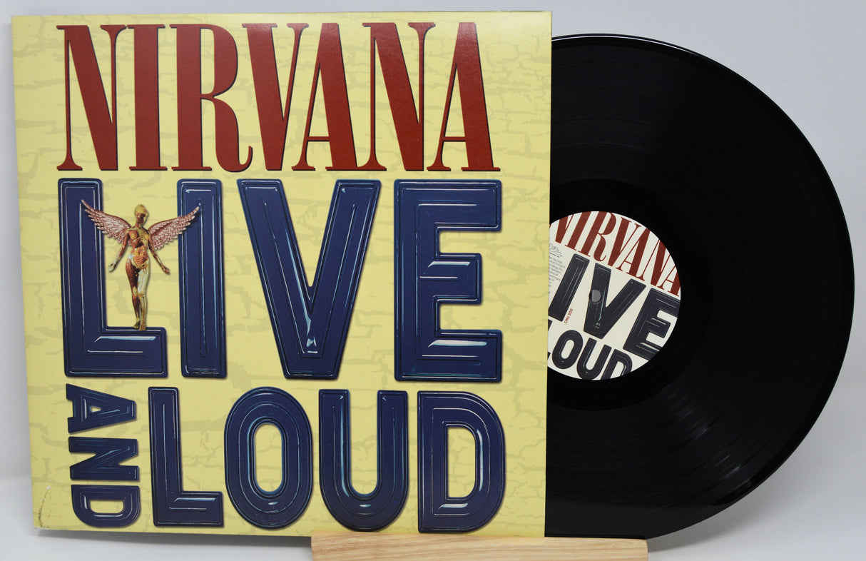 Vinyl record with 'Nirvana Live and Loud' cover on a light gray background